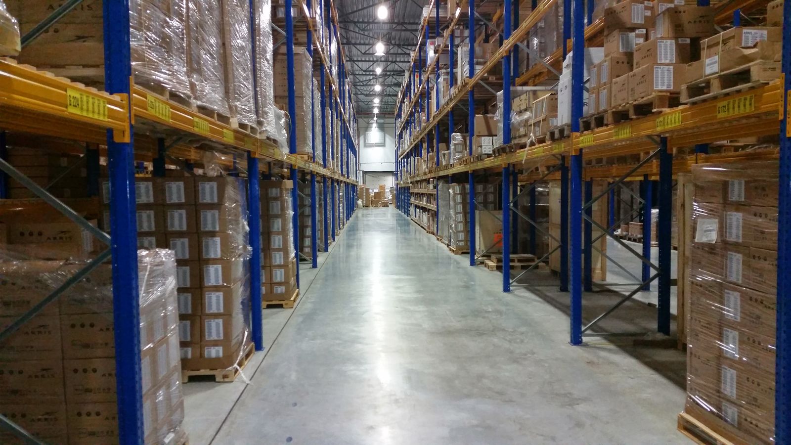 Organized warehouse aisle with palletized cartons